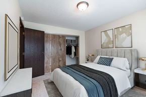 Bismarck apartment for rent - a bedroom with a bed and a closet. Bismarck, ND Hannifin Apartments