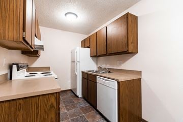 Bismarck apartment for rent - a kitchen with a stove refrigerator and a sink