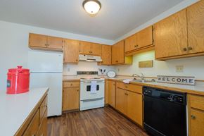 Fargo apartment for rent - a kitchen with white appliances.  Fargo, ND Hunters Run Apartments