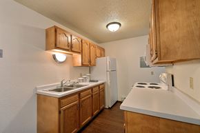 Fargo apartment for rent - a kitchen with white appliances and wooden cabinets and a white refrigerator
