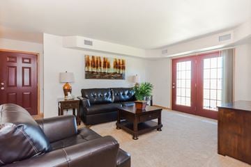 Grand Forks townhouse for rent - a living room with leather couches and a coffee table