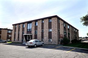 Fargo apartment for rent - a brick apartment building with a car parked outside. Fargo, ND North Manor Apartments