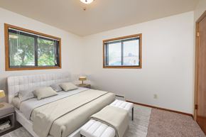 Moorhead apartment for rent - a white bedroom with a bed and two windows. Moorhead, MN Northwood Apartments