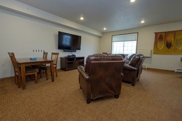 Fargo apartment for rent - an open living room with leather furniture and a television