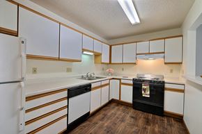 Fargo apartment for rent - Kitchen with white cabinets and black appliances at Park Place Apartments in Fargo, ND, 58103