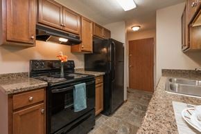 Bismarck apartment for rent - Kitchen with Black Appliances at Parkview Arms Apartments in Bismarck, ND