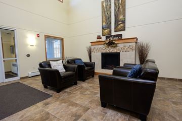 Fargo apartment for rent - a living room with leather furniture and a fireplace