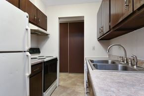 Roseville apartment for rent - a kitchen with a sink and a refrigerator and a door. Roseville, MN Rosedale Estates