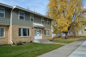 West Fargo townhouse for rent - an apartment building with a sidewalk and a tree. Fargo, ND Sheyenne Terrace