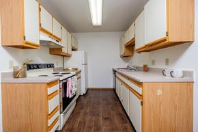Fargo apartment for rent - a kitchen with white appliances and wooden cabinets. Fargo, ND South Pointe Apartments