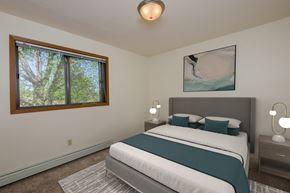 Fargo apartment for rent - a bedroom with a bed and window. Fargo, ND South Pointe Apartments