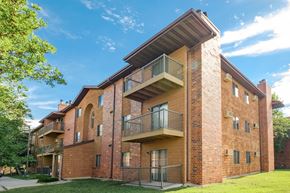 Fargo apartment for rent - a brick apartment building with balconies and a blue sky. Fargo, ND Southview Village Apartments