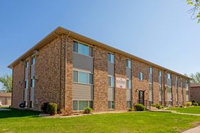 Fargo apartment for rent - a three level apartment building with green grass out front. Fargo, ND Southwind Apartments