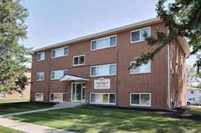 Fargo apartment for rent - a brick building with a sidewalk in front of it. Fargo, ND Spring Apartments