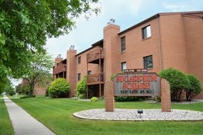 Fargo apartment for rent - a large brick building with a sign in front of it