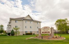 Fargo apartment for rent - a three story apartment building with a sign out front. Fargo, ND Summit Point Apartments