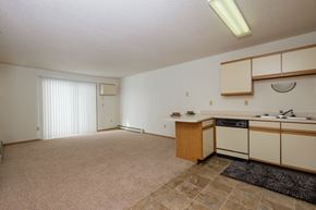 Fargo apartment for rent - a living room with a glass sliding door. Fargo, ND Twin Parks Apartments.
