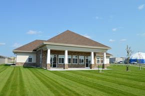 Fargo apartment for rent - a building with a lawn in front of it. Fargo, ND Urban Plains Apartments