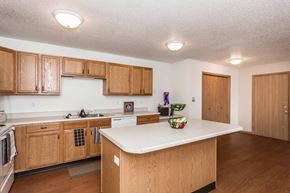Grand Forks apartment for rent - Grand Forks, ND Vista Apartments. a kitchen with wooden cabinets and a white counter top
