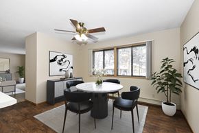 Anoka apartment for rent - a dining room with a table and chairs and a ceiling fan. Anoka, MN Dellwood Estates