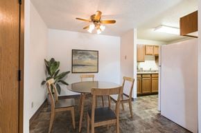 Bismarck apartment for rent - Bismarck, ND Arbor apartments. a dining area with a table and chairs and a kitchen in the background