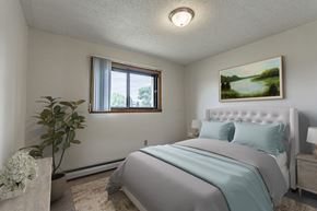 Bismarck apartment for rent - Bismarck, ND Eagle Sky II. A bedroom that features a comfortable bed with neatly arranged bedding and a serene ambiance. Soft lighting creates a relaxing atmosphere, providing a peaceful space for rest and rejuvenation.