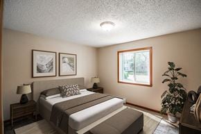 Bismarck apartment for rent - a bedroom with a bed and a window. Bismarck, ND Eastbrook Apartments.
