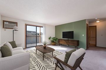 Bismarck apartment for rent - a living room with a white couch and a table and a television