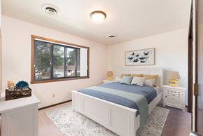 Bismarck apartment for rent - Bismarck, ND Riverpark Apartments  a bedroom with a large window and a large bed with blue bedding