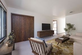Bismarck apartment for rent - Bismarck, ND Riverpark Apartments The room features large windows that offer scenic views of the surrounding area, comfortable seating, and modern decor. The room has a closet near the door for convenience to store outdoor clothing