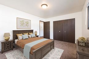 Bismarck apartment for rent - Bismarck, ND Rosser Apartments. A bedroom with a large bed and a closet.