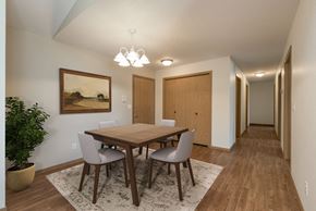 Bismarck apartment for rent - Bismarck, ND Sierra Ridge Apartments. The room showcases a modern dining table with four elegant chairs, well-placed lighting, and a sophisticated ambiance for enjoyable meals and gatherings.