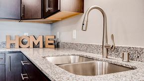 Circle Pines apartment for rent - a kitchen with a sink and home letters on the counter. Circle Pines, MN Lexington Lofts