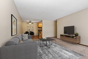 Coon Rapids apartment for rent - comfortable living room in Parkview Estates, Coon Rapids. The room showcases a cozy sofa, a coffee table, and tasteful decor. Soft lighting creates a warm and inviting atmosphere.