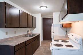 Coon Rapids apartment for rent - a kitchen with white appliances and wooden cabinets and a white stove. Coon Rapids, MN Robinwood Apartments
