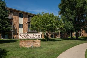 Bismarck apartment for rent - A brick building with a sign that says Garden Grove Apartments. Bismarck, ND Garden Grove Apartments