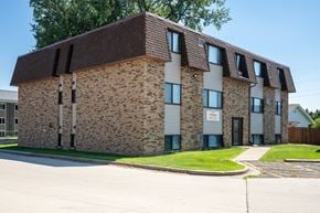 Bismarck apartment for rent - A brick building with a brown roof. Bismarck, ND Arbor 400 Apartments