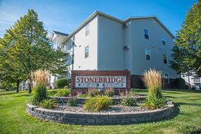 Fargo apartment for rent - A building with a sign that says Stoneridge in front of it. Fargo, ND Stonebridge Apartments