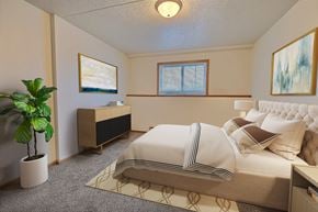 Fargo apartment for rent - a bedroom with a bed and a potted plant. Fargo, ND Alden Pines Apartments