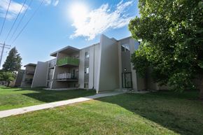 Fargo apartment for rent - the exterior of an apartment building with grass and a sidewalk