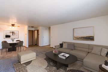 Fargo apartment for rent - a living room with a couch and a coffee table and a dining room