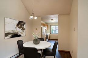 Fargo apartment for rent - Fargo, ND Bayview Apartments. A dining area with a table and chairs and a kitchen in the background