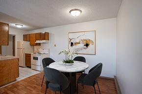 Fargo apartment for rent - a dining room with a table and chairs and a kitchen. Fargo, ND Bella Vista Apartments