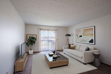 Fargo apartment for rent - a living room with a white couch and a coffee table