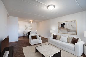 Fargo apartment for rent - a living room with white couches and chairs and a table. Fargo, ND Bella Vista Apartments