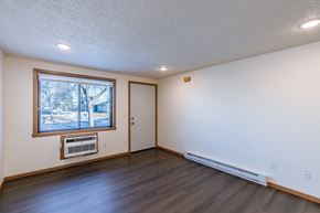 Fargo townhouse for rent - an empty living room with a window and a door. Fargo, ND Berkshire Apartments