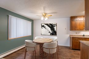 Fargo apartment for rent - a dining room with a table and chairs and a ceiling fan. Fargo, ND Betty Ann Apartments