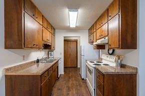 Fargo apartment for rent - a kitchen with white appliances and wooden cabinets. Fargo, ND Betty Ann Apartments