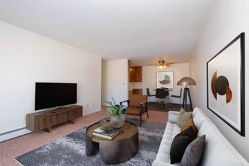 Fargo apartment for rent - a living room with a white couch and a television