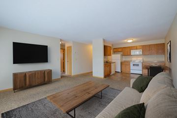 Fargo apartment for rent - a living room with a couch and a coffee table and a kitchen